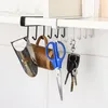 A kitchen organizer with hooks holding various items. Produktbild-Vorschau