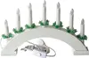 A white electric candle arch with seven candles and green decorative elements, shown on a white background. Voir les images du produit