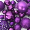 A collection of purple Christmas ornaments of various sizes and finishes. Produktbild-Vorschau