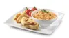 A white rectangular plate with a bowl of dip, pita bread pieces, and cherry tomatoes. Náhľad obrázku produktu