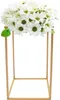 A bouquet of white flowers with green leaves is displayed on a gold metal stand. Náhled obrázku produktu