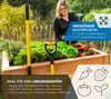 A woman is tending to a raised garden bed filled with vegetables and plants. Tools are visible in the foreground. Náhled obrázku produktu