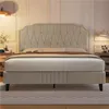 A beige upholstered bed with a tufted headboard is shown in a bedroom setting. Produktbild-Vorschau
