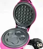 An open pink waffle maker with a paw print mold on the bottom plate and a standard waffle mold on the top plate. Náhled obrázku produktu