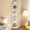 A white corner bookshelf filled with decorative items and books, placed in a room with a yellow chair and a floor lamp. Produktbild-Vorschau