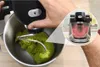 A hand is operating a food mixer with green dough. Náhled obrázku produktu