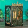 A 3D DIY book nook model, designed to look like an ornate, gothic-style doorway or gate, with intricate details and a green and gold color scheme. The background is a blurred teal and green, suggesting an underwater or mystical environment. Náhled obrázku produktu