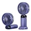 Two purple handheld fans shown against a white background. One fan is upright, displaying a digital readout, and the other is folded. Produktbild-Vorschau