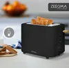 A black Zeegma toaster with two slices of toast in it, placed on a kitchen counter with some bread and jam in the foreground. Produktbild-Vorschau