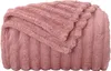A folded pink fleece blanket with a ribbed texture. Náhľad obrázku produktu