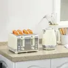 A cream and silver toaster with four slices of toast and a matching cream kettle on a speckled countertop. Produktbild-Vorschau
