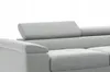 Close-up view of a light gray sectional sofa, focusing on the headrest and armrest. Produktbild-Vorschau