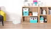 A collection of storage boxes on a wooden shelf unit. Náhľad obrázku produktu