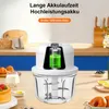 A mini electric chopper is displayed on a kitchen counter with food items like cake, croissants, milk, and berries in the background. Produktbild-Vorschau
