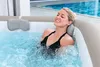 A woman relaxing in a hot tub. Produktbild-Vorschau