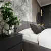 A bedroom scene with a bed, nightstand, and a large mural on the wall. Produktbild-Vorschau