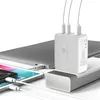 A white multi-port charger is connected to a laptop, tablet, and phone. Produktbild-Vorschau