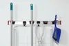 A wall-mounted organizer holding cleaning tools and a cord. Anteprima dell’immagine prodotto
