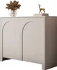A light gray two-door cabinet with arched doors, decorated with a vase of dried flowers and a golden deer figurine on top. Produktbild-Vorschau