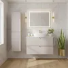 A modern beige bathroom vanity with a sink and mirror, set against marble tiles. Produktbild-Vorschau