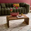 A living room scene with a couch, coffee table, and rug. Produktbild-Vorschau