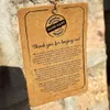 A close-up of a product tag with text in multiple languages. Produktbild-Vorschau