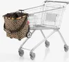A shopping cart with a leopard print bag attached. Voir les images du produit