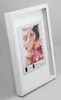 A framed picture of a woman with flowers, displayed on a light gray background. Produktbild-Vorschau