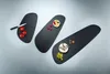 Three black serving boards of different sizes are arranged diagonally on a light gray background. The boards are decorated with small food items. Anteprima dell’immagine prodotto