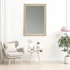 A living room scene with a mirror, armchair, and side table. Produktbild-Vorschau