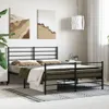 A bedroom scene featuring a black metal bed frame with bedding. Podgląd zdjęcia produktu