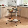 A kitchen scene with a rolling cart filled with kitchen items. Anteprima dell’immagine prodotto