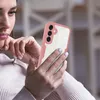 A woman is holding a pink and clear phone case with a Samsung phone inside. Produktbild-Vorschau