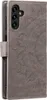 A close-up view of a gray flip phone case with a mandala pattern embossed on the cover. Produktbild-Vorschau