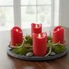 A set of four red LED candles arranged on a slate base with moss and antlers. Produktbild-Vorschau