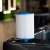 A white pool filter cartridge with a blue top and bottom sits on the edge of a dark gray hot tub. Produktbild-Vorschau