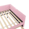 Close-up view of the corner of a pink upholstered daybed with a wooden slat mattress support. Podgląd zdjęcia produktu