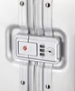 A close-up of a TSA-approved combination lock on a silver suitcase. Produktbild-Vorschau