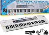 A white electronic keyboard with a microphone and power adapter, presented in a box with marketing text. Produktbild-Vorschau