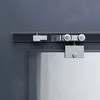 A close-up view of a sliding glass door track and roller system. Produktbild-Vorschau