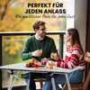 A couple enjoys drinks and fruit on a balcony next to a portable table. Produktbild-Vorschau