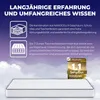 A mattress is shown against a background of clouds and a purple sky, with marketing text and icons above it. Produktbild-Vorschau