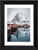 A framed picture of red houses on stilts in a snowy landscape. Anteprima dell’immagine prodotto
