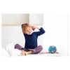 A young boy is stretching in bed next to a blue alarm clock. Voir les images du produit