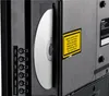 Close-up view of the back of a MEDION television, showing a DVD being inserted into the player, along with various ports and warning labels. Produktbild-Vorschau