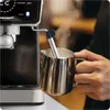 A person is using a steam wand from an espresso machine to froth milk in a metal pitcher. Produktbild-Vorschau
