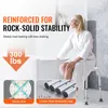 A woman is sitting on a shower stool next to a bathtub. The image highlights the product's stability and load-bearing capacity. Podgląd zdjęcia produktu