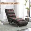 A gray chaise lounge chair with red circles indicating massage points, placed on a patterned rug in a well-lit room. Produktbild-Vorschau