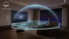 A person is sitting on a couch in a modern living room, watching a TV. A 3D sound wave visualization emanates from the TV and surrounds the viewer, indicating an immersive audio experience. Náhled obrázku produktu