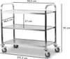 A stainless steel serving trolley with three shelves, shown with dimensions indicated by measurement lines and text. Voir les images du produit